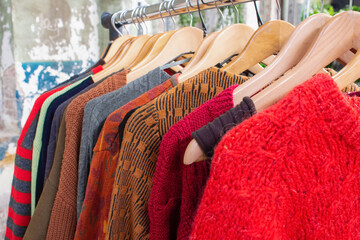 Second hand clothes on hangers for donation and reselling. Garage sale or economic shopping...