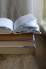 Stack of books on a table. Selective focus.