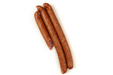 Three sausages lie on a white background.The sausage is sliced. Isolated