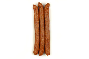 Three sausages lie on a white background. Isolated