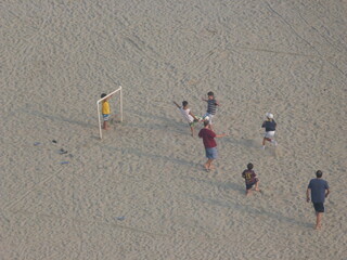 children playing on the beach soccer