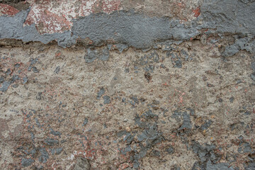 abstract background of a shabby old concrete wall painted grey close up