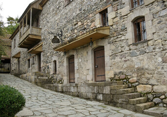 Fototapeta na wymiar Traditional stone and wooden buildings, now used as shops, eateries, and a hotel, in the Dilijan Historic Centre (Shaambeyan Poghots), Dilijan, Armenia