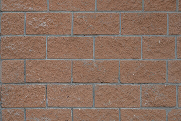 abstract background of brown stone lined wall close up