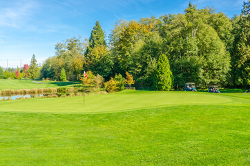 Fototapeta na wymiar Golf course with gorgeous green and pond.