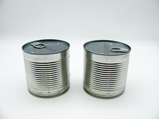 Two tin closed cans standing side by side on a white background