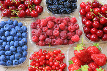 Fresh berries on wooden background, strawberry, blueberry, raspberry, blackberry, cherry and red currant