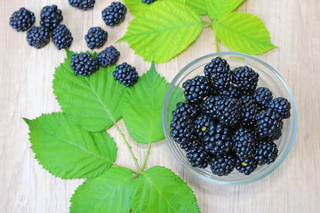 Fresh blackberries on wooden background, close up of berries juicy ripe fruit