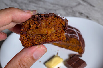 Brazilian  gingerbread (honey bread) in a male hand. Top view and selective focus