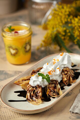 Assorted Russian pancakes with different fillings: red caviar, salmon, meat, chocolate