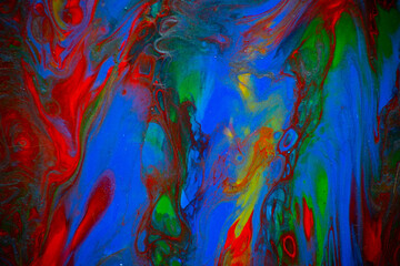 Texture in the style of fluid art. Abstract background with swirling paint effect. Liquid acrylic paint background. Red, green, yellow and blue colors.