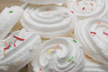 Close-up of white meringues with colored sprinkles