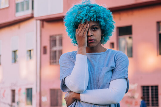 afro american girl on the street with hand on face