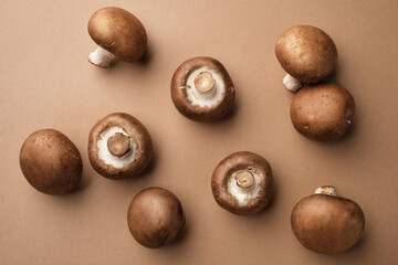 Whole royal brown champignons on brown background. View from above.