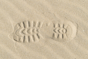 Fototapeta na wymiar View of a shoe footprint in the sand