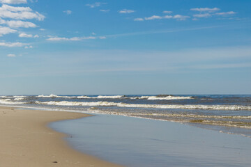 Fototapeta na wymiar View of the sandy beach of the Baltic Sea on a windy day