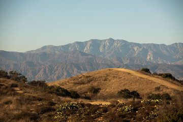 Day time view of the hills of Diamond Bar, California, USA stacked in front of the San Gabriel Mountains.