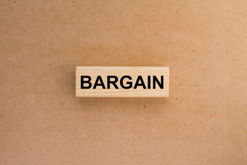 Wooden blocks with text Bargain on the cardboard background