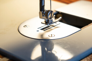 Part of the sewing machine while working, extreme close up