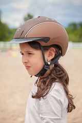 Fototapeta na wymiar Young Girl Wearing a Horse Riding Helmet