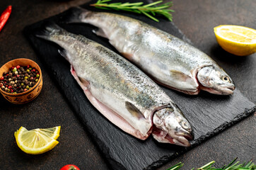 raw fish trout on a stone background.