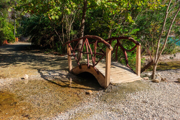 Small arched wooden footbridge in Goynuk canyon in Antalya province, Turkey