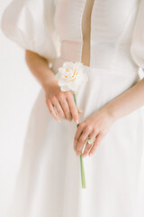 the bride holds a white flower