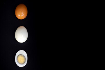 three eggs on black background