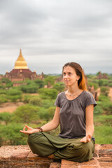 Woman relaxing on the pagoda at sunset in Bagan 
