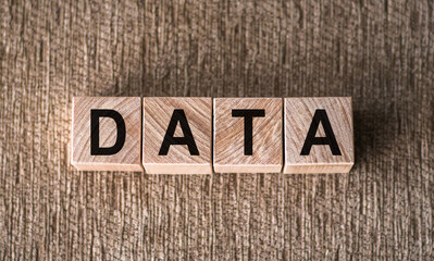 Fototapeta premium DATA word written on wooden blocks on a brown background.