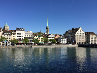 The Limmat River and the Limmatquai waterfront promenade in Zürich, Switzerland. The tower of the...