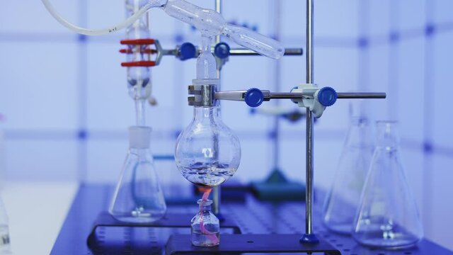 Synthesis of organic matter in a chemical laboratory. Distillation of liquid by heating the flask