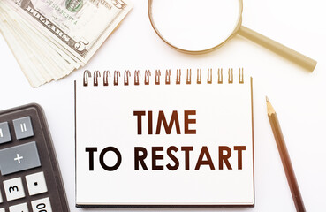 TIME TO RESTART - text written on a notebook with office background.