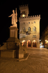 Fototapeta na wymiar Town hall square and statue of liberty in the historic center of San Marino late in the evening in summertime