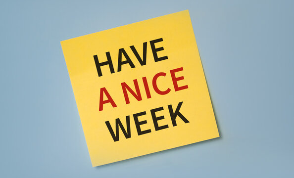 HAVE A NICE WEEK text on a yellow sticker agains blue backgroun. Minimalism concept.