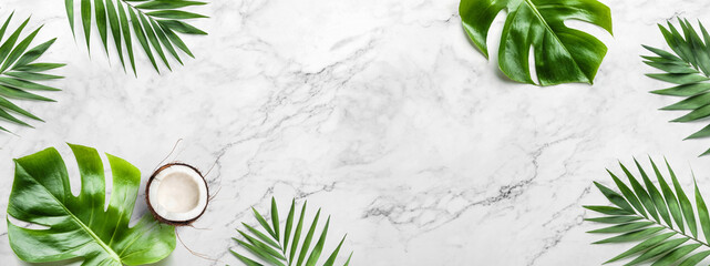 Tropical leaves, Monstera plants and coconut on light marble background. Summer concept, flat lay,...