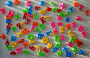 Fototapeta premium multicolored plastic letters of the Russian alphabet on a light background, letters on magnets for teaching literacy