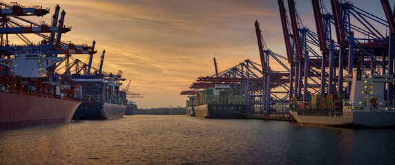 Container terminal in the port of Hamburg at sunset 