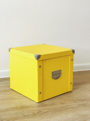 yellow folding storage box made of durable cardboard for storing papers, documents, various items