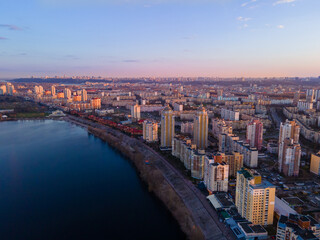 Aerial view from a drone to the sunset over the city of Kiev on Obolon embankment