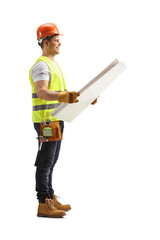 Full length profile shot of a construction worker checking a blueprint