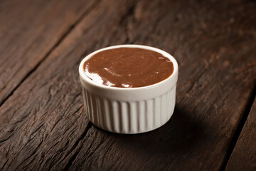 Chocolate ganache. Ramekin with chocolate sauce.