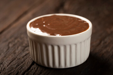 Chocolate ganache. Ramekin with chocolate sauce.