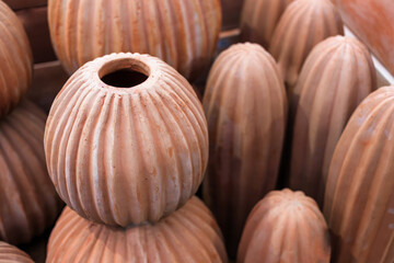 Stacked red clay pots for planting at sale in a garden center