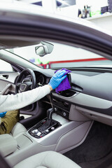 Fototapeta na wymiar A man cleaning car interior, car detailing (or valeting) concept. Selective focus.