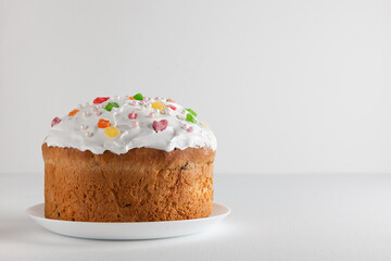 Easter cake. Traditional kulich with raisins and meringue on a white background. Homemade cakes for Easter celebrations.