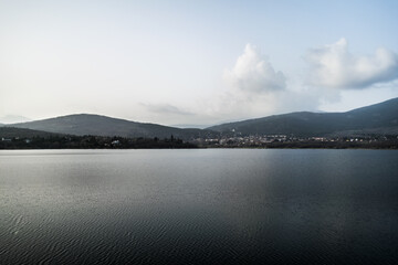 Lake with some houses in the background