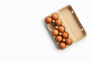 Chicken eggs in egg box on white background.
