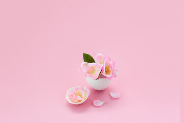 Spring sakura flowers in egg shell. Minimal creative Easter concept. Selective focus, place for text.