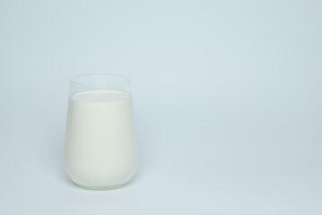 Glass of milk on a white background
